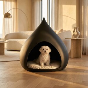 Small dog in the TailThink Big Chestnut designer pet cave in matte black in a penthouse living room